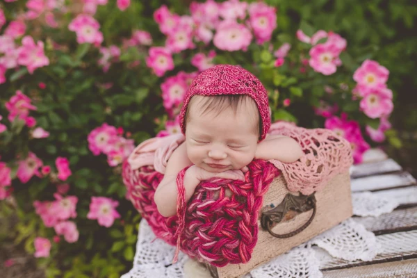 We call this "Pretty in pink"! When I received this Bonnet and blanket in the mail from Lil Luxe, I knew exactly what I wanted to do with it!!! Luckily my flowers bloomed that week :) Baby girl decided to add a tiny smirk all on her own! 