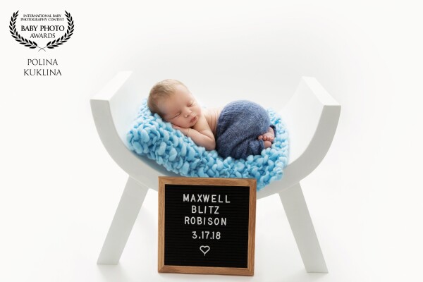 Baby Max was 9 days old at his newborn session. I used a curved white bench to accentuate the birth announcement on a square blackboard, which Mom wanted to include.