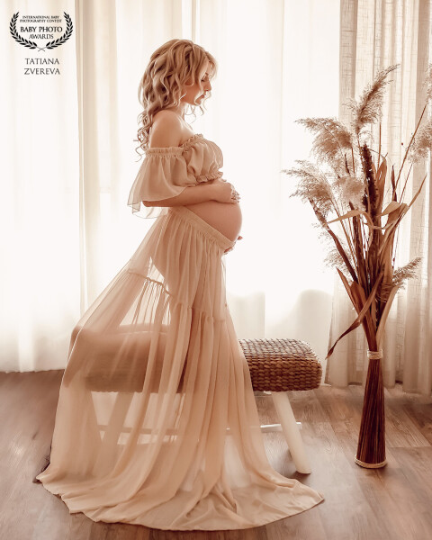 In this portrait, I aimed to capture the delicate beauty and serenity of pregnancy. The soft, flowin...