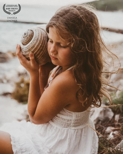 I hold the shell to my ear and hear the sound of the sea.