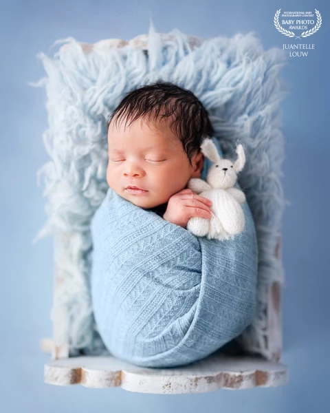 Adorable sleepy baby with bunny