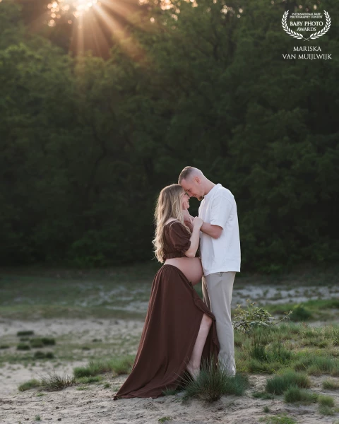 A quiet moment of connection between two parents-to-be, captured in the soft warmth of golden hour....