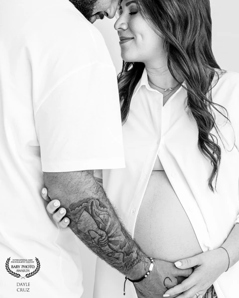 Strength meets softness in this timeless black-and-white tribute to anticipation and shared connecti...