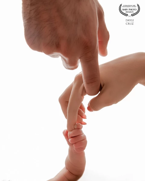 A powerful and tender macro portrait capturing the profound connection of a new family.