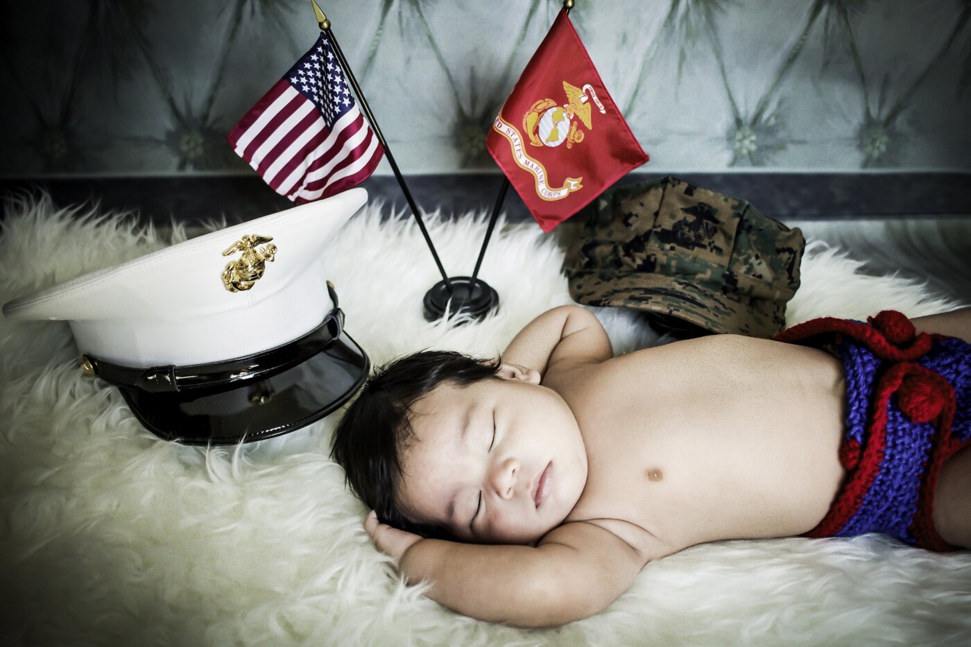 This photo of Andrew was taken to honor his father, a retired United States Marine who has returned safely after a couple of tours of duty.  When his mother and I were planning Andrew's session, I had a special US Marine inspired diaper cover made while his mom gathered her husband's uniform and accessories. It was truly a humbling and emotional session on a very hot summer day in my studio.