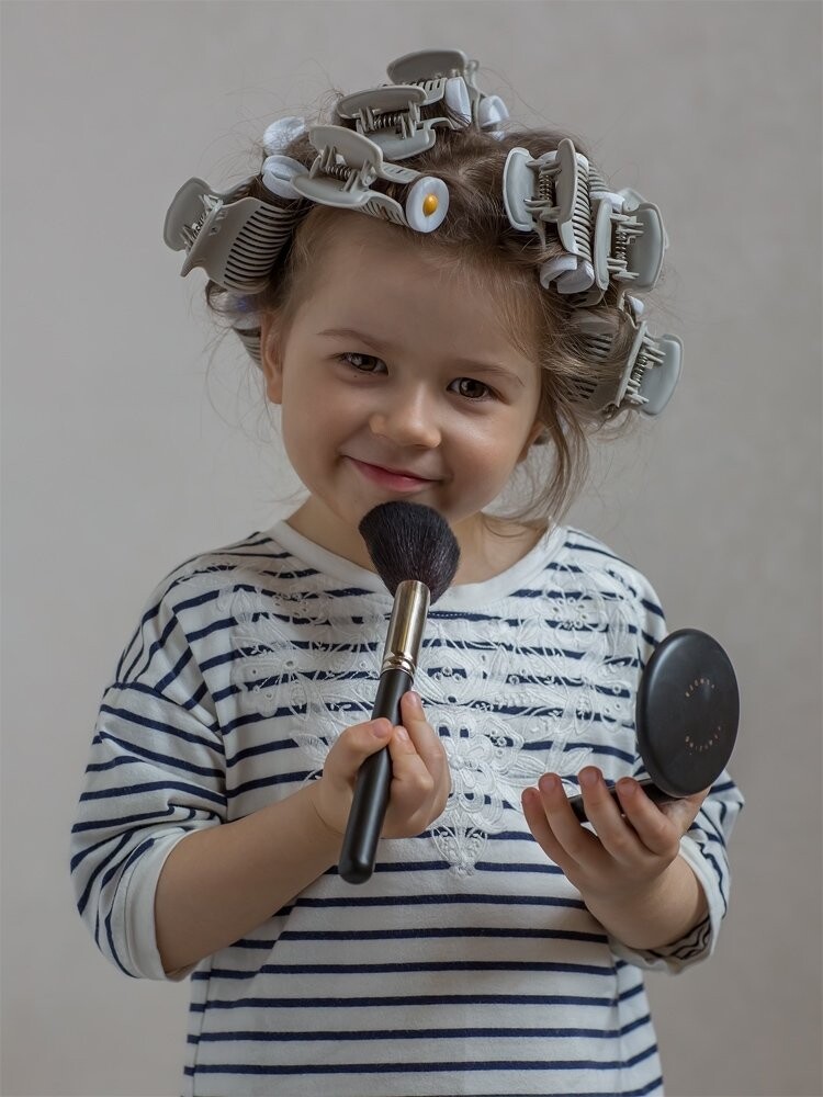 This shoot was done while my daughter was preparing for her Dad's Birthday Party.I just took advantage of this natural situation. I noticed that the stripes in her T-shirt perfectly matched the stripes in her curlers. All I did was put my baby near the window and took the photo. It was a spur of the moment photo, there was no planning involved.