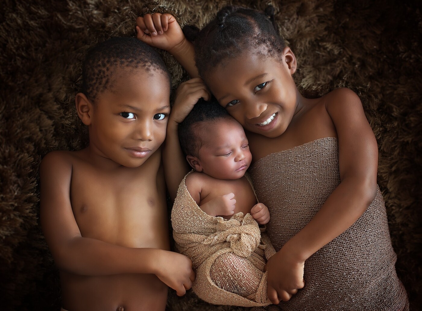 Abraham, Aaliyah and Aisha. I spotted little Aaliyah whilst on the school run to pick up my own daughter. I asked her mum if she would like to come in to do a shoot and she agreed. I could tell how much love Aaliyahs brother and sister had for their youngest sibling and wanted to get the perfect shot of them altogether.