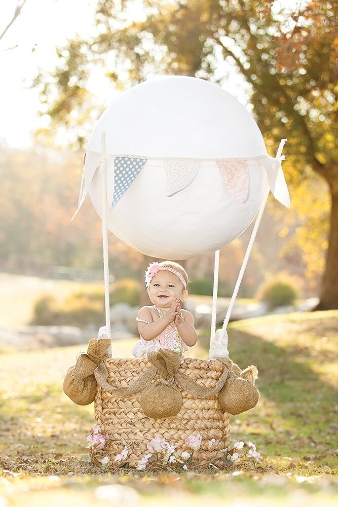This beautiful little girl celebrated her first birthday with a whimsical hot air balloon "ride"!  It's truly special capturing the excitement and wonder a child portrays. 
