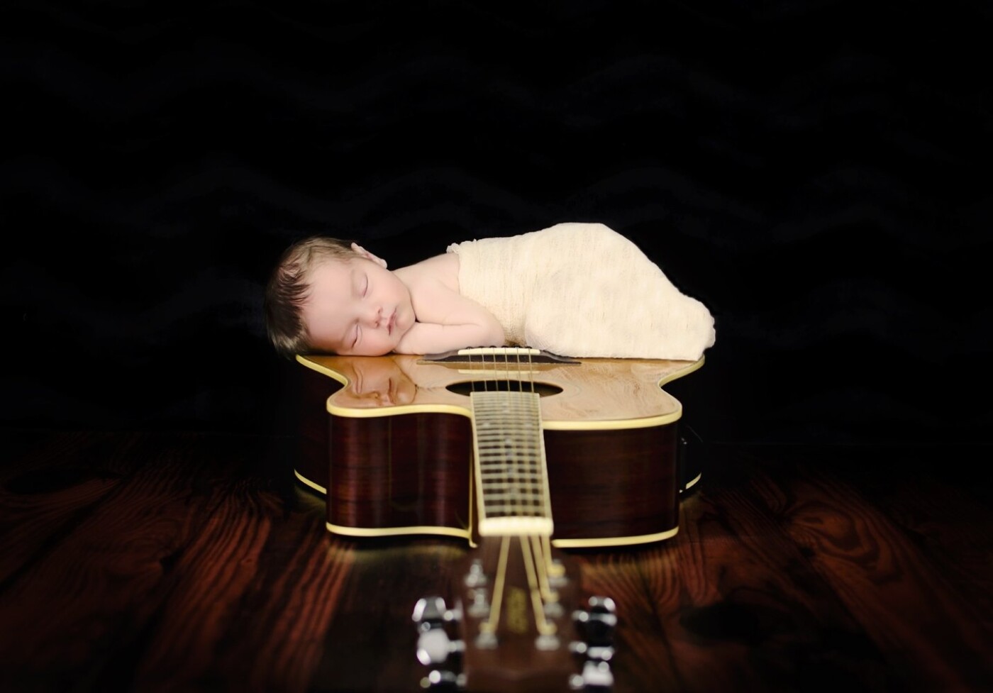 This is Braxton 12 Days. His Dad plays in the band at church and really wanted to incorporate the guitar in some way with their sweet boy!I Loved his reflection in the guitar!