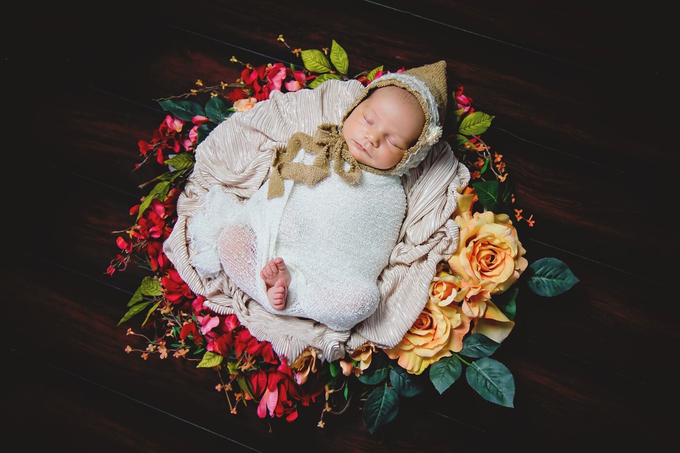 I was going for a vintage theme and baby Londyn at 14 days old was the perfect baby for it.  Totally sweet and easy to photograph she dreamed away in her perfect little bed of fire tipped orange roses. 