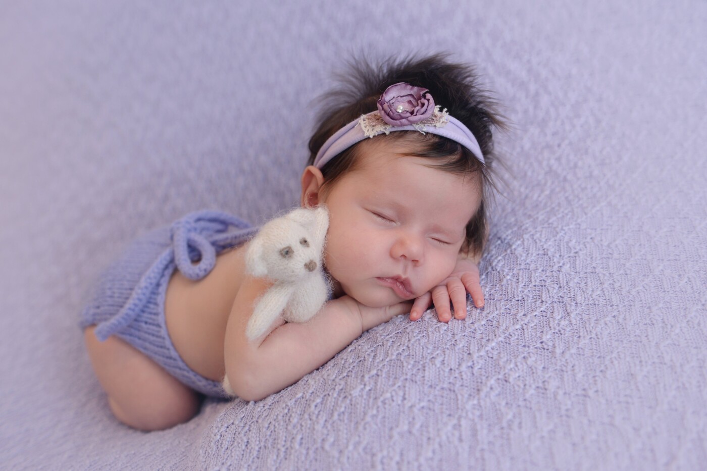 This lady is so gorgeous! She is half South-American and half Dutch and she has the best hair ever! At the time of the Newborn Shoot she was already 1 month old, but she slept the entire shoot. She looks absolutely stunning in purple, with her little bear-friend.