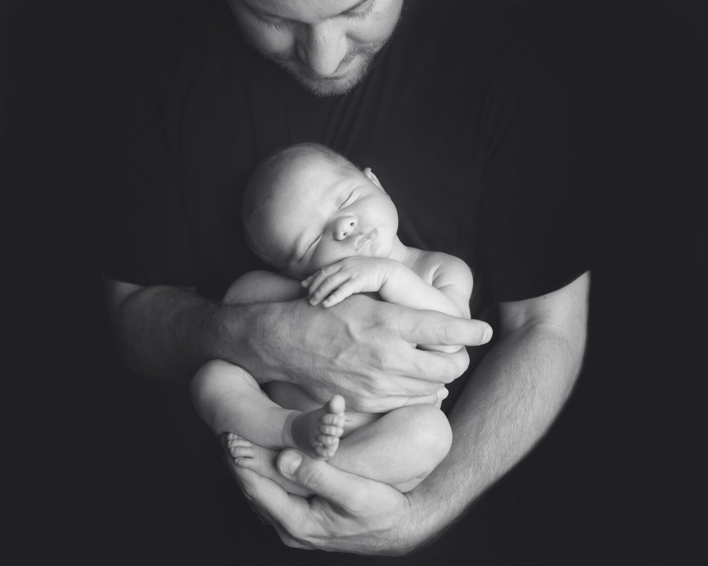 This pose is my favorite for the new Dad.  It really shows the contrast of just how small baby is.  Safe and secure in Dad's hands.