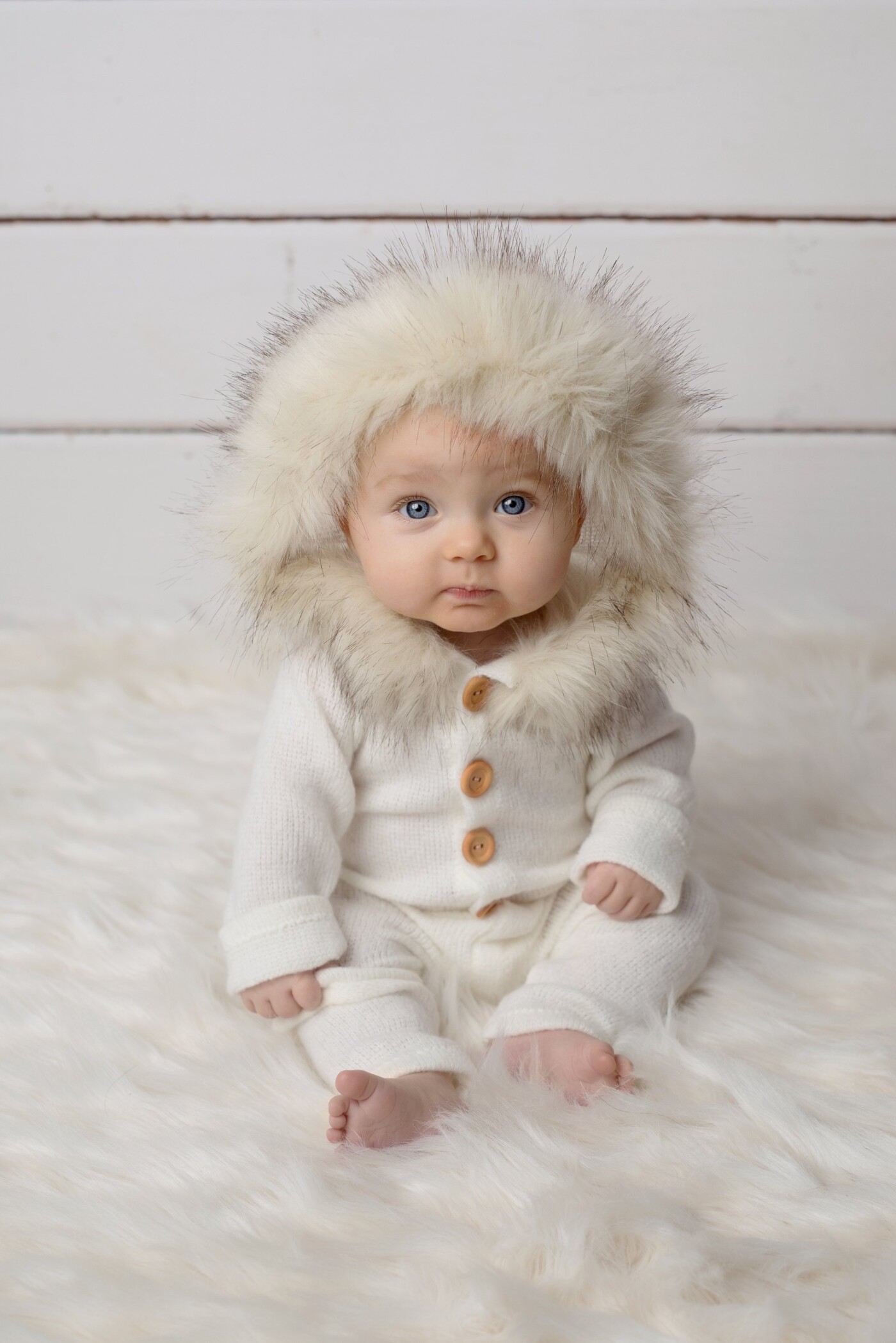 Taken just days before a big blizzard in Winnipeg, this doll like seven month old baby girl looked adorable in all things white and wintery.   