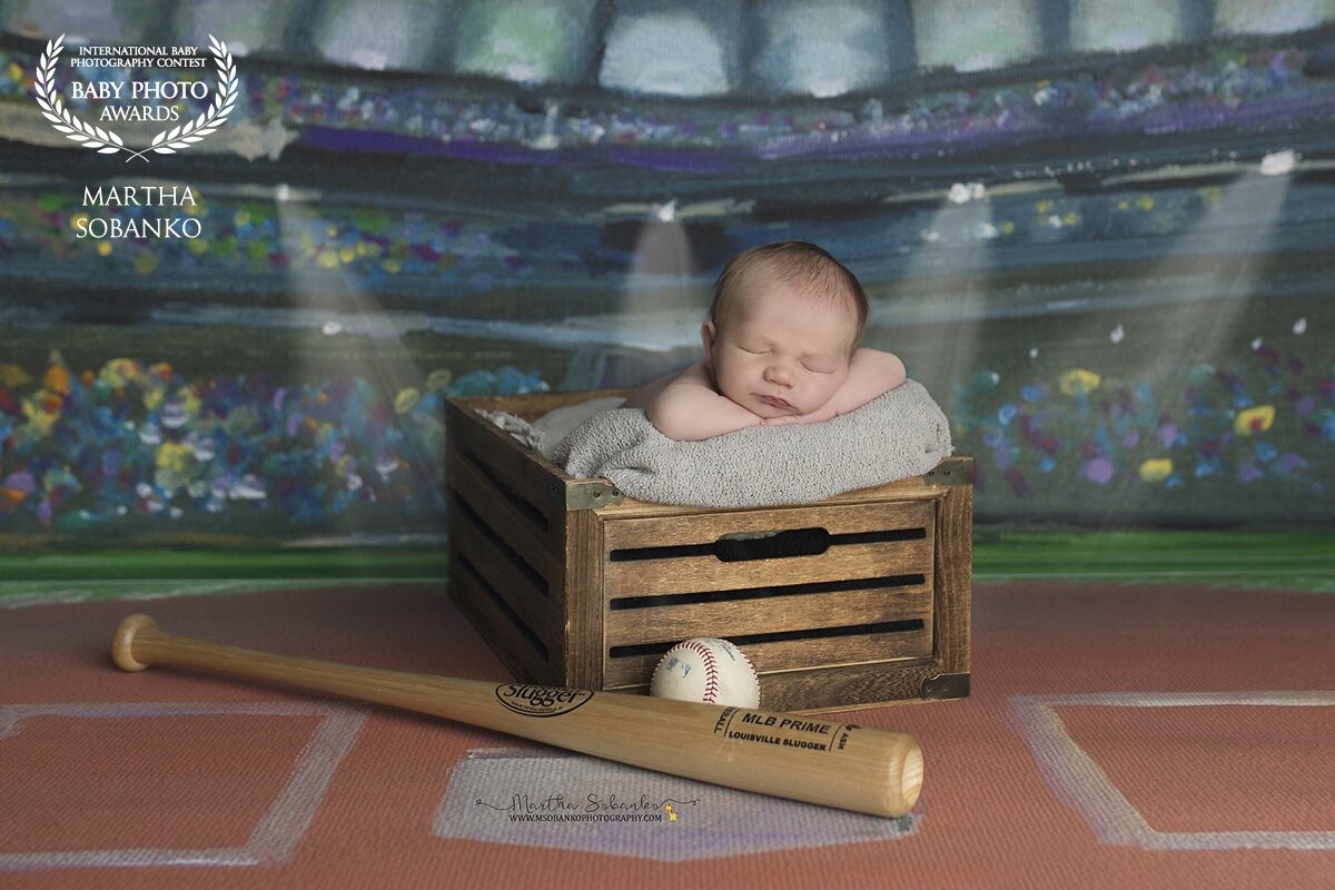 This little guy's mom and dad were really into sports so it was only fitting we would use a sports backdrop for a few of the photos.  Future slugger?  