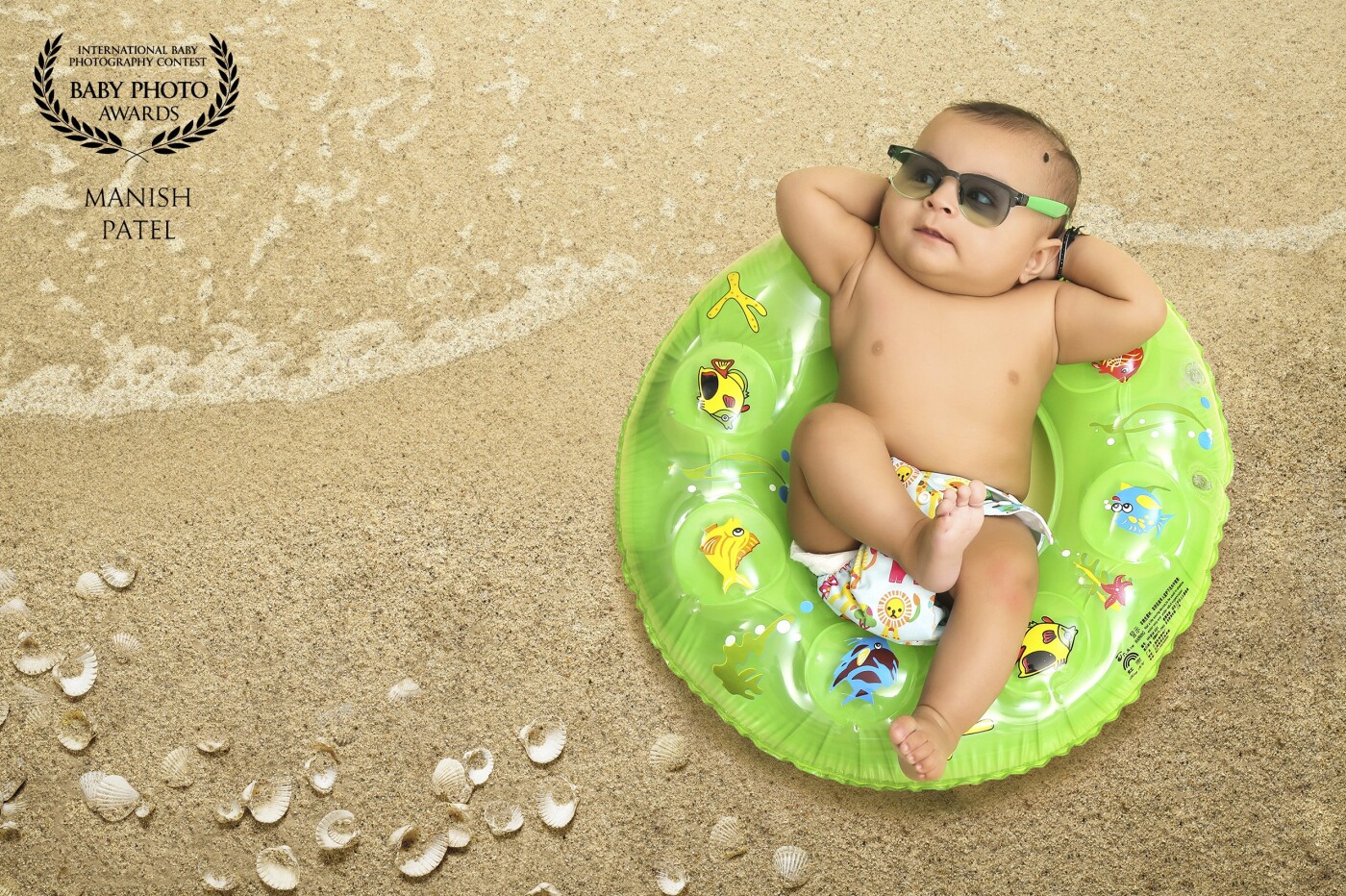 This image was taken in Studio. The little boy was getting a bit bored, so I encouraged him to have some play time and concept of beach theme around. I love the expression on his face capturing childhood and playing. 