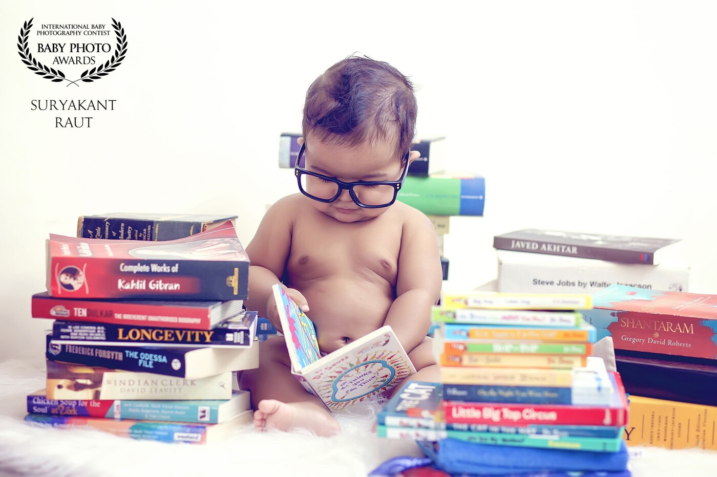 We were doing this session at this tiny munchkin's home and we found out that the mother was a voracious reader and had a huge collection of books. Apparently, little 'Vikrant' was fond of his books too. This image is named "The tiny little scholar".