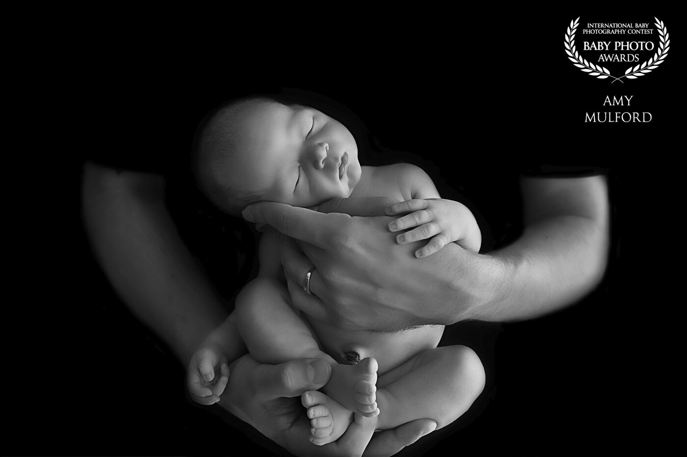 Anytime I have a nice sleepy baby, I will put them in dads hands so that I can get this gorgeous moody, black and white image. Moms always gush over them!