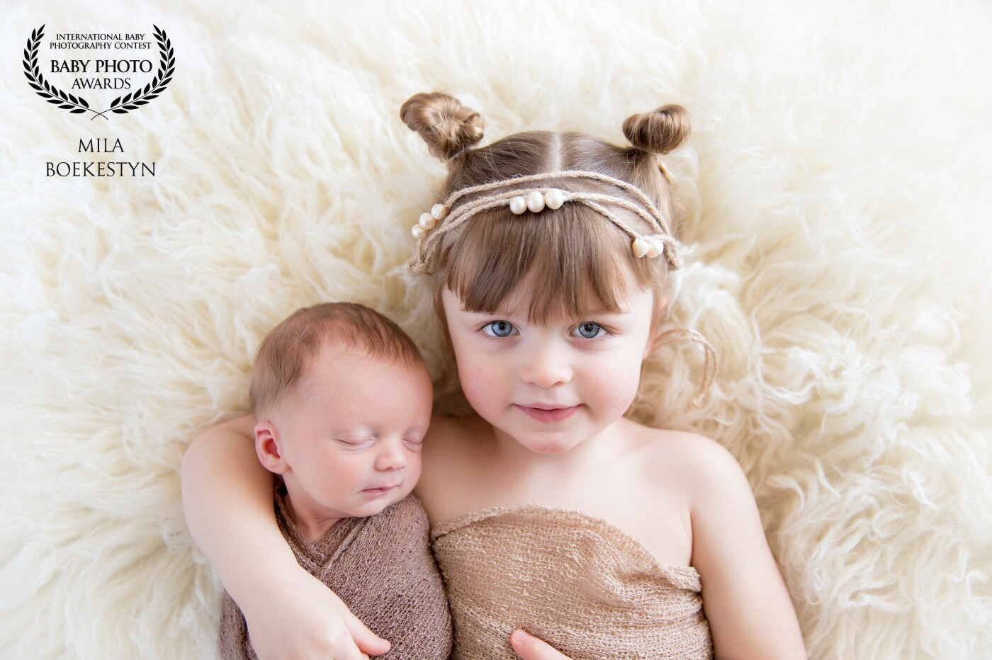 These siblings are 2 years apart and as every newborn photographer knows, it could be challenging to pose a 2 year old sibling with a newborn, however this big sister was super patient, caring and super gentle with her baby brother.  "I got you little brother" 