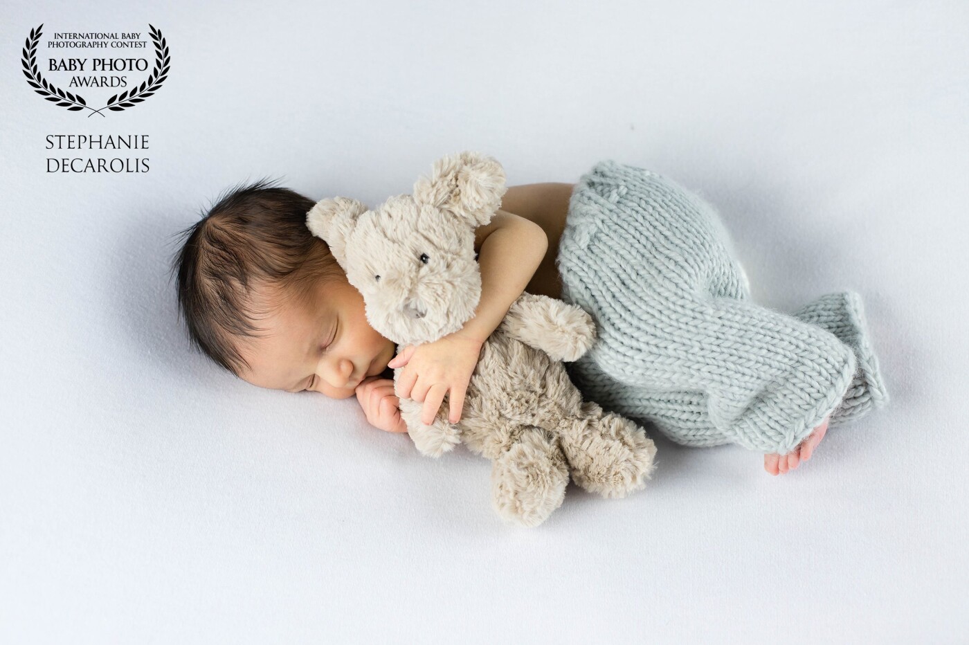 Meet Connor: He was only 6 days new when this photo was taken, and he’s just as sweet as could be! He LOVED snuggling with his little teddy bear. 