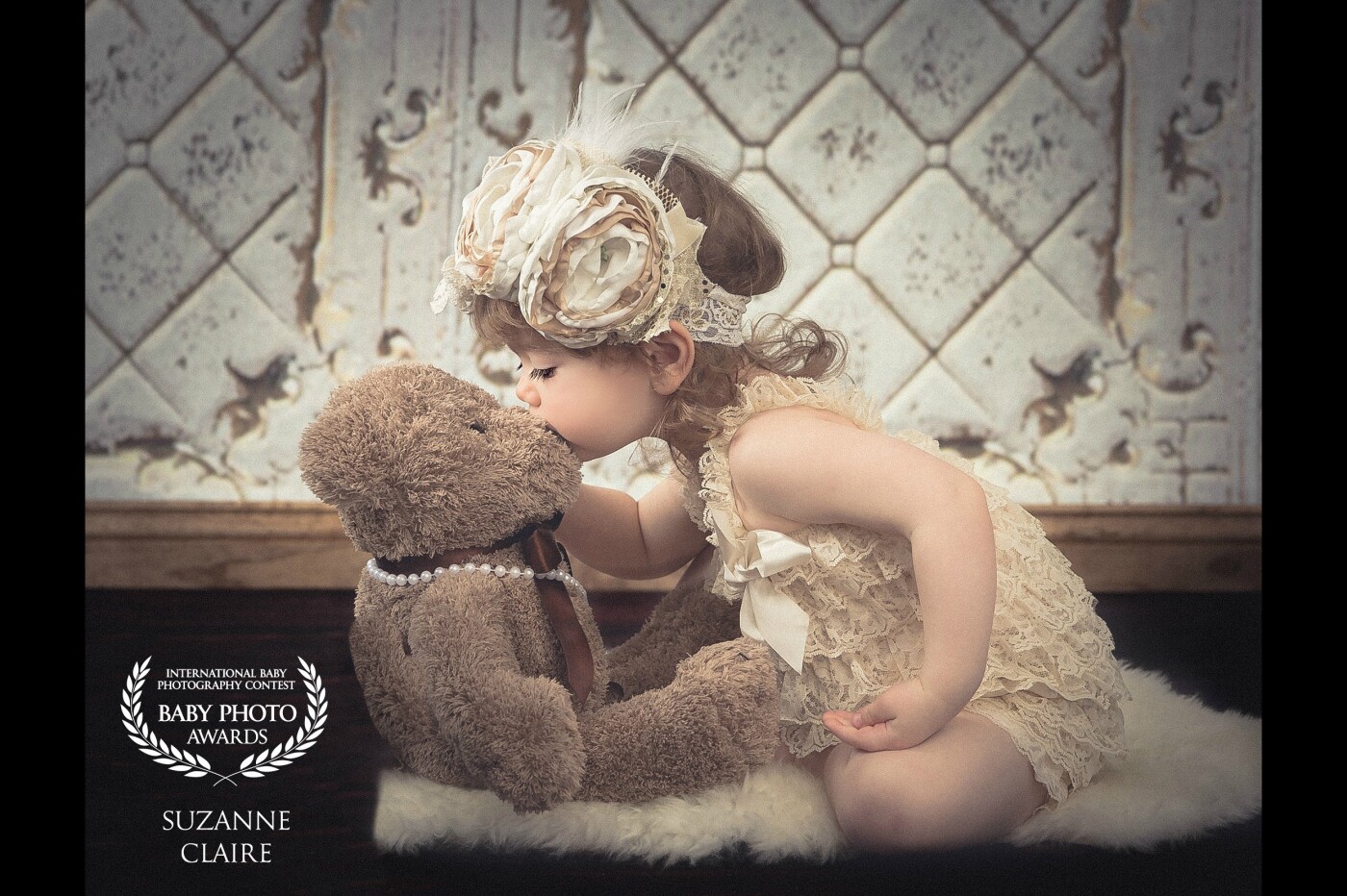 This adorable little girls photo was taken in my home studio with my Profoto lighting system. This was one of my favorite clients daughters two-year-old birthday pictures. <br />
We had so much fun playing dress up with this old teddy bear. I love capturing the innocence of a child.