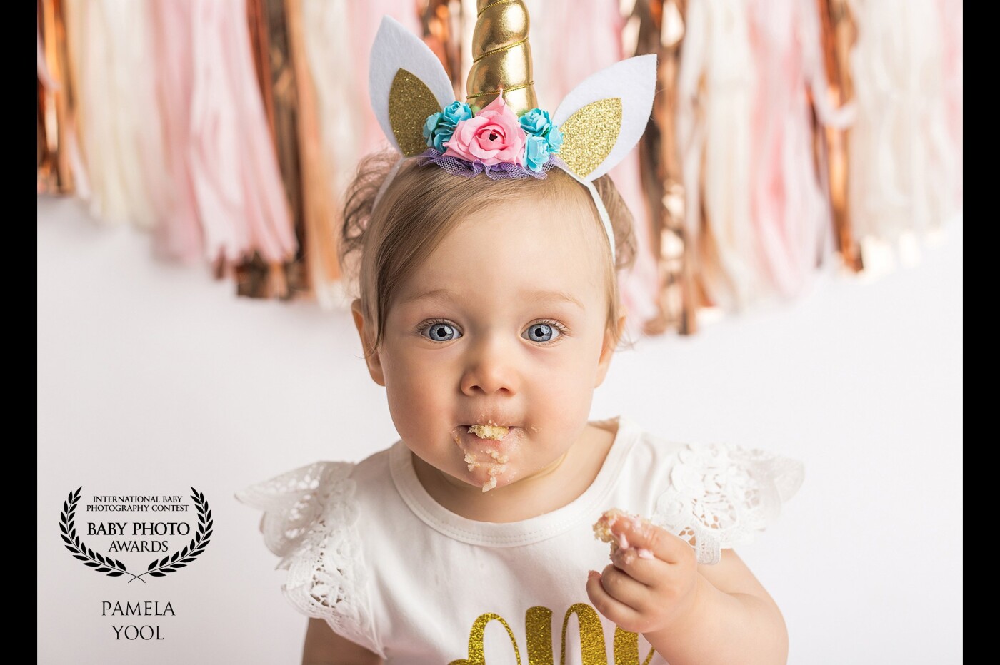 What better way to celebrate turning ONE, than to do a Unicorn Theme Cake Smash Session! Here are some adorable first birthday portraits of Baby R, who recently celebrated with a stylized cake smash photoshoot at my Toronto studio. I just adore Baby R in all of these photos…her entire gallery makes me smile. She was a little shy at first, but quickly warmed up once we brought out the cake and smiled for the rest of the session. Every detail was carefully planned and coordinated - the gold unicorn horn headband, rosette covered pastel pink cake matched with pink and gold tassel garland. What a fun cake smash session it was! 