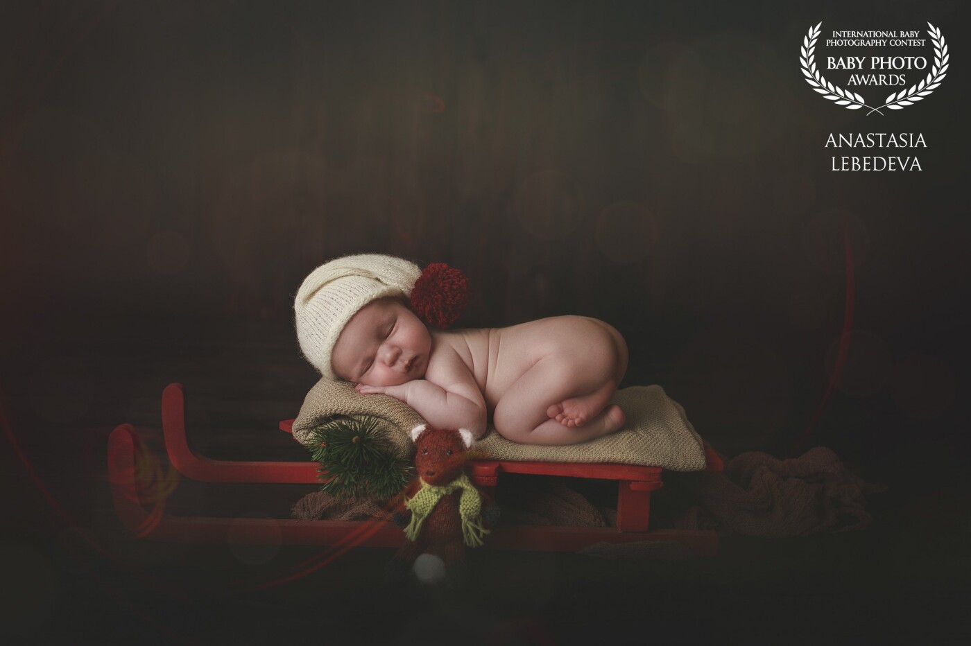 There's a newborn boy on the photo. He sleeps sweetly and dreams of gifts from Santa Claus. <br />
He has no idea that the most important gift for the New Year is he)