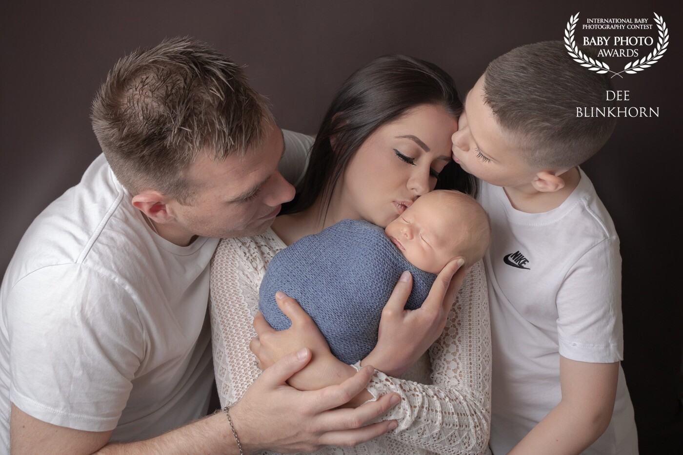 A tender moment captured in time. A moment this family thought they would never have. After a long journey of eight years. This beautiful family of three became four 