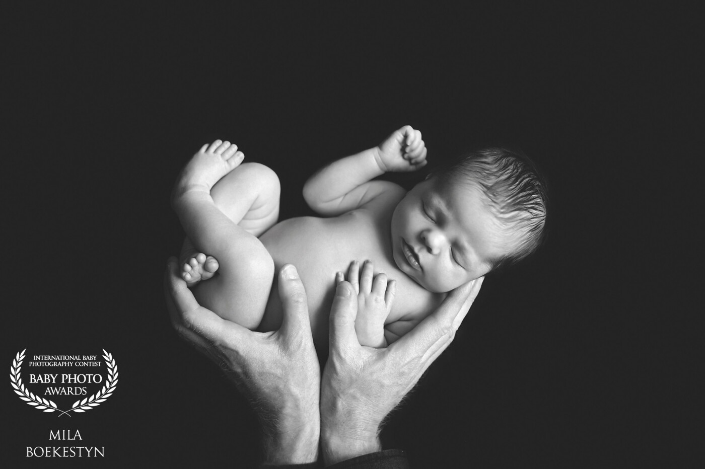 What can be better than a black and white image of your brand new baby in your hands?  I believe the reason many photographers like to recreate this image is that it puts into a perspective - how truly little newborn babies are - they can easily fit into your hands!