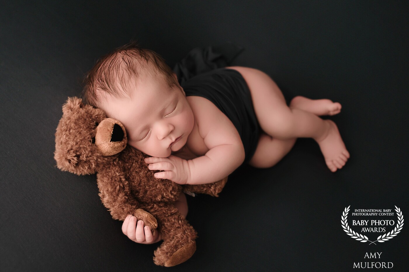 Boston here is a rainbow baby. His big brother passed away at just one day old. Boston came to me for his rainbow baby newborn session and wasn't a big fan of me posing him. Mom brought along this little teddy bear that belonged to his brother and as soon as I laid it next to him, he snuggled right up and fell fast asleep. I know mom and dad will treasure this image forever. 