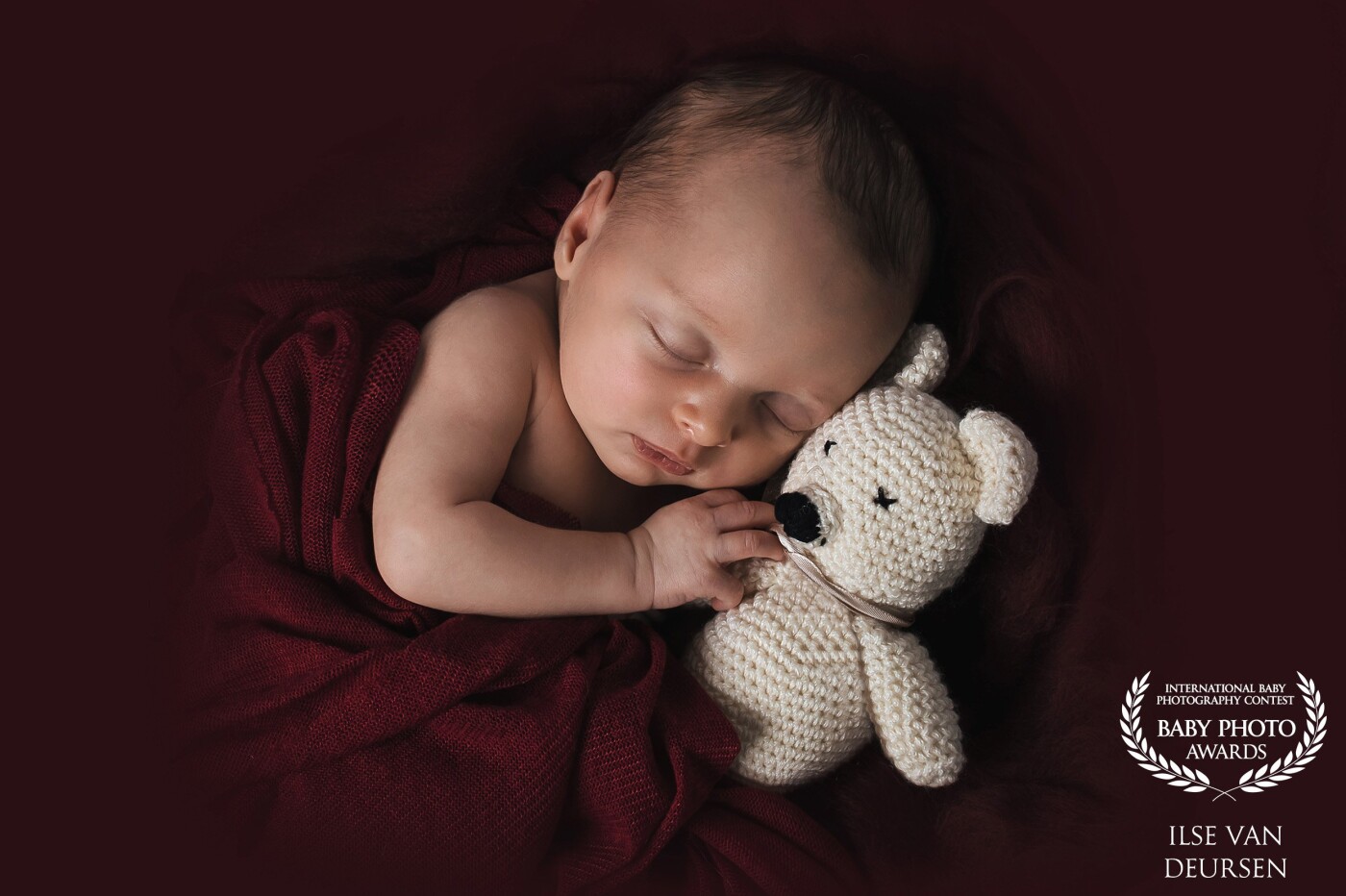 This little girl has, in fact, a twin brother. They were together in my studio for a twin newborn shoot. <br />
But in between two shots, she was sleeping and looked so cute. So I carefully put a wrap around her, gave her a bear ... et voilà :)