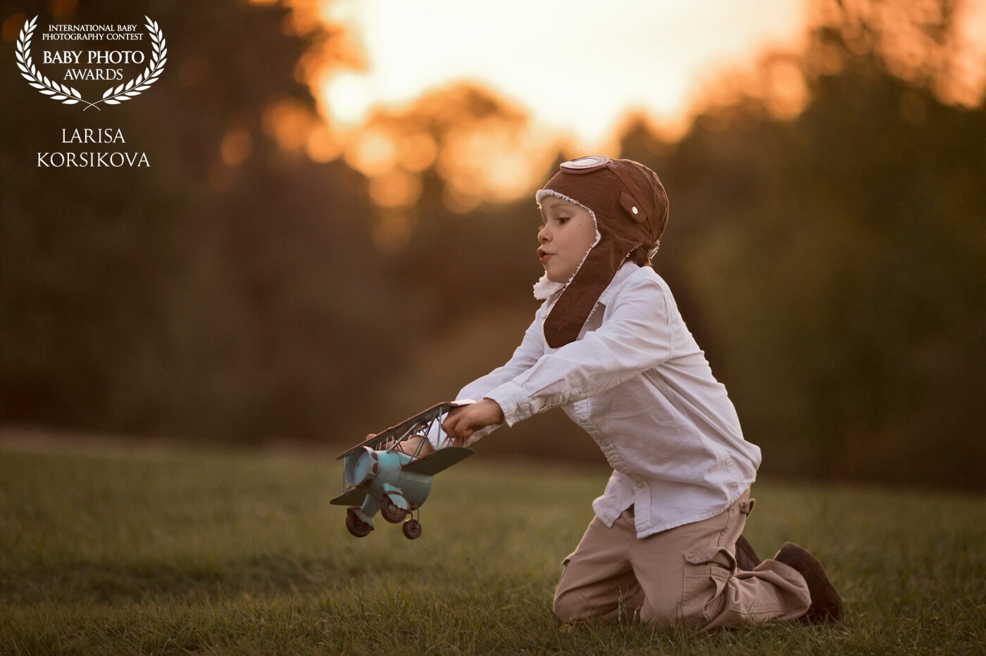 My son Daniel. I like to take pictures with vintage accessories and the style of the 30s. This picture was taken around 7-8 pm at the park (time of sunset).