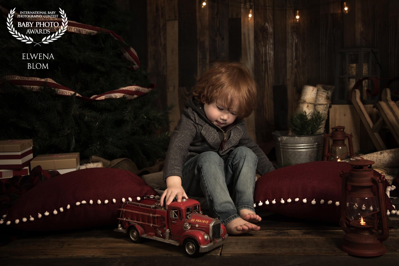 For me, this photo just captured the essence of Christmas - finding a quiet moment from all the chaos and just enjoy something that makes you happy - like playing with a truck.  This little guy with his flaming red hair found that moment away from his two sisters and the craziness of the session and I was so happy I could get in in-camera. With the low light and dark background, it just reminded me of an old painting.  