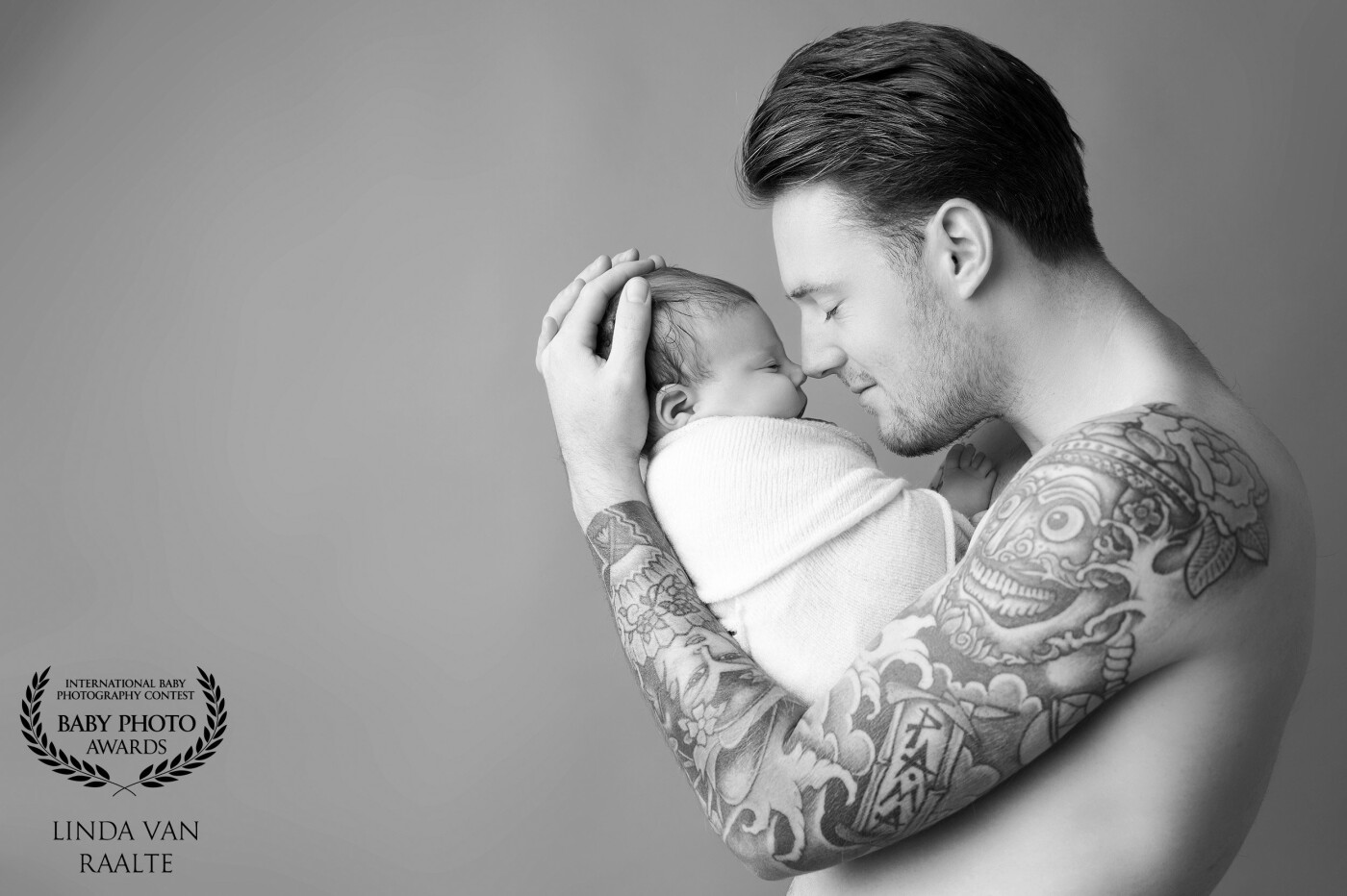 Love this picture of the little bay girl in dad's strong (tattooed arms) I love the contrast between the sweet little baby and the strong fierce arms of the father.