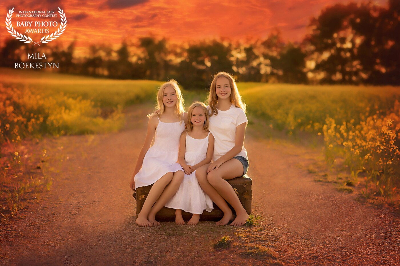 In Canada, Alberta we have beautiful Canola fields in July and as you drive by the countryside - all you see are fields and fields of beautiful yellow flowers. What can be better than 3 sweet sisters on a dirt road surrounded by Canola field flowers and a sunset? This photo was inspired by my friend's @HocusFocusPhotography portrait of her daughters she took a few years back. Check out her work - she is amazing!