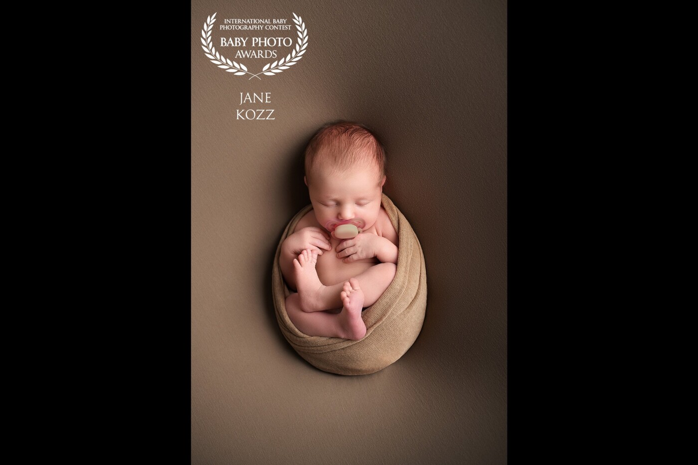 Minimalism in newborn photography. I like it because you see a baby with wrap only. It looks like a baby inside the mom's stomach. So natural and beautiful.
