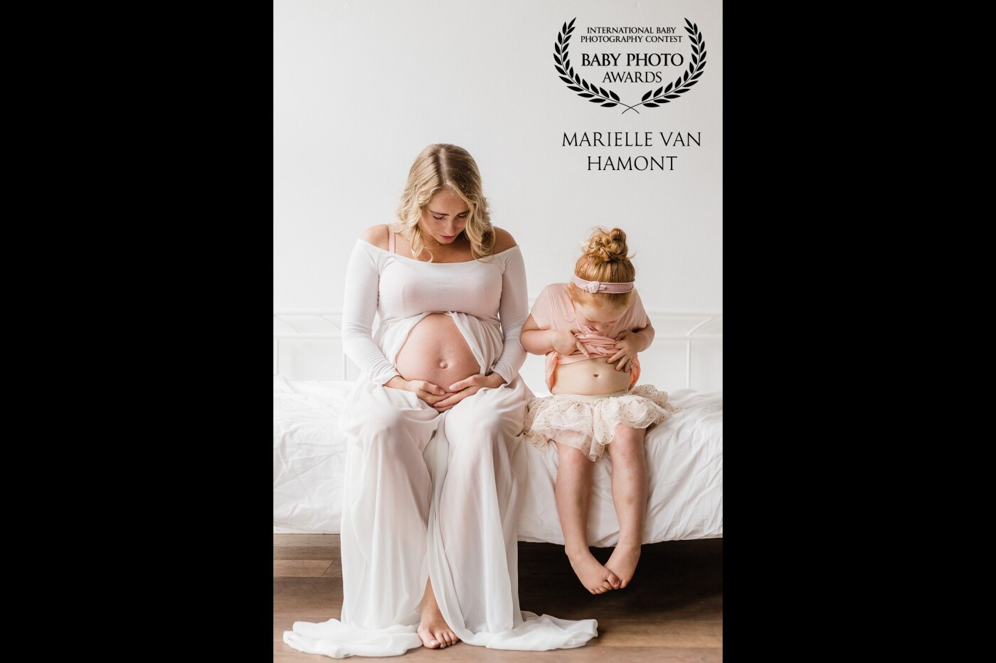Mother and daughter came to the studio for their pregnancy shoot. The little girl was so excited that she was going to have a baby brother and was eager to show us where he was. Not only with mom's belly, but also in hers.