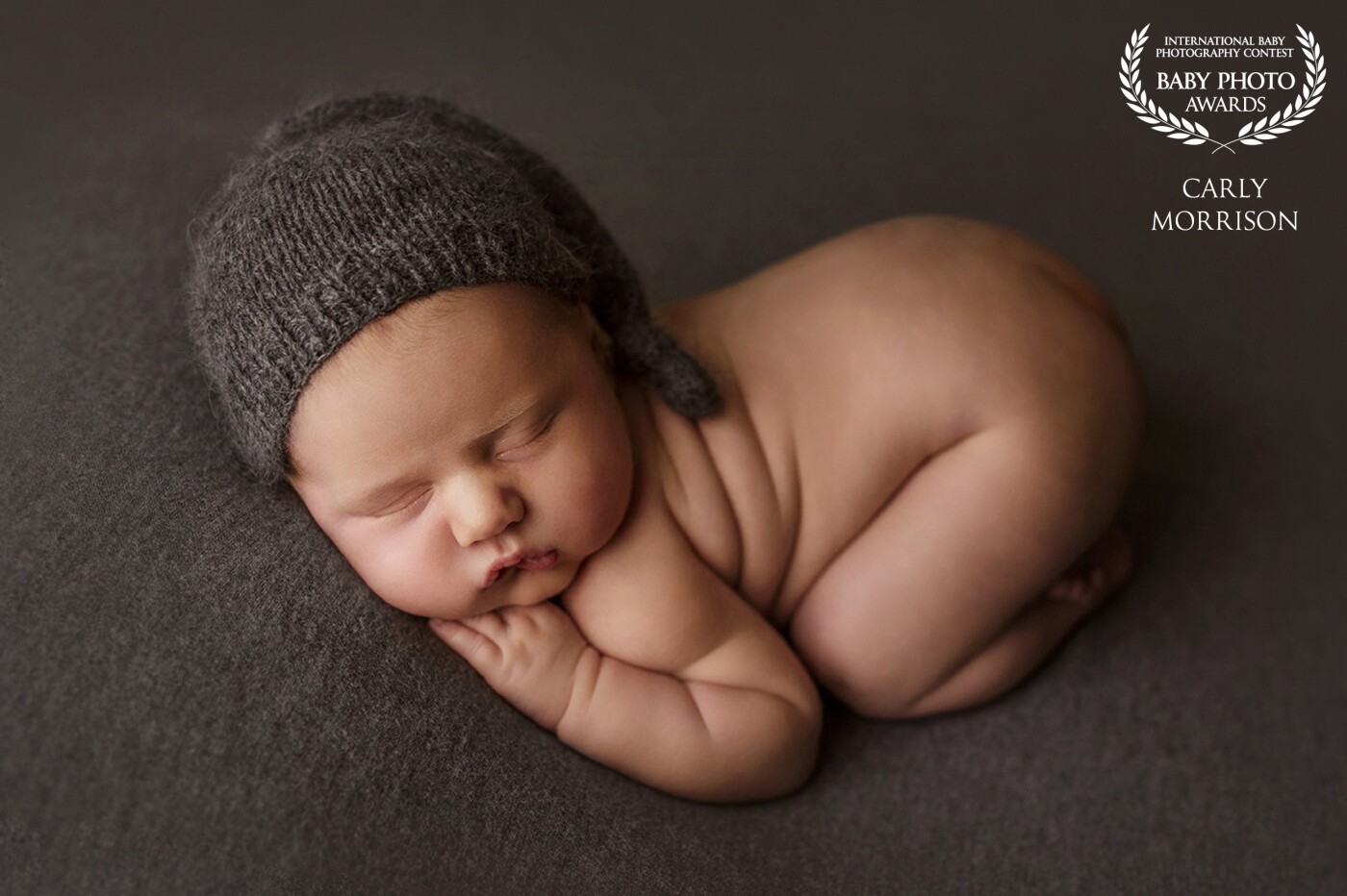 One of my favorite parts of photographing the precious newborn stage is seeing the reactions on the parent's faces when they see their final images! This little guy was all squished up in a tushie-up pose with the most adorable little hat on. Needless to say, his parents were smiling from ear to ear when they saw this image!
