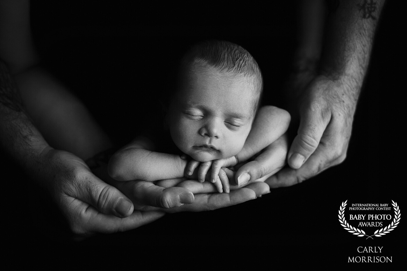 We always forget how tiny our children were as newborns when they are all grown up. That is why as a newborn photographer I always love using mom and dad's hands as reference to show how perfect and precious they really were. This little boy's mom and dad now have this beautiful memory to cherish forever on the wall in their home so they can remember those tiny fingers forever and ever.