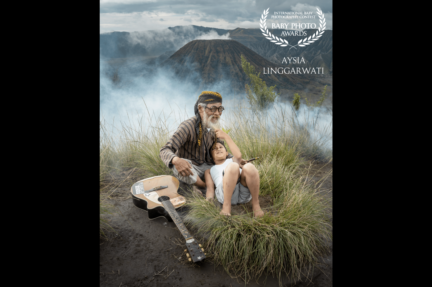 Grandfather with his grandson enjoying one fine morning blissfully. Mount Bromo, located in East Java, is indeed inviting a lot of tourists because of the beautiful natural scenery from the heights of the mountains.<br />
Location: Mount Bromo hill, East Java - Indonesia.