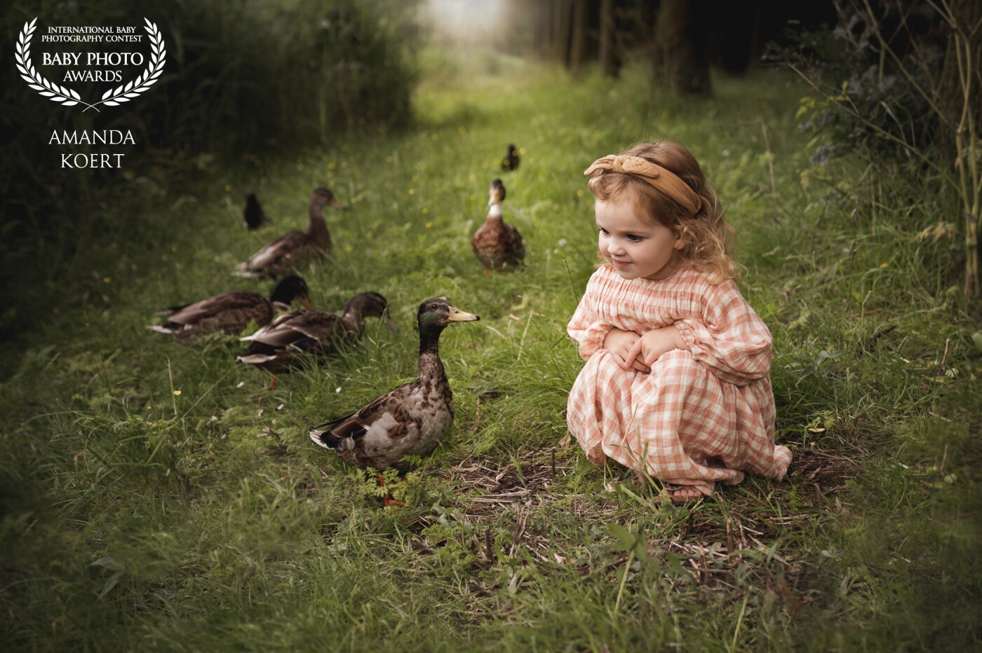 Every day we walk past the ducks, chickens, deer and all other animals. For me, this is such a precious photo because it is my own daughter near our house in her favorite spot.