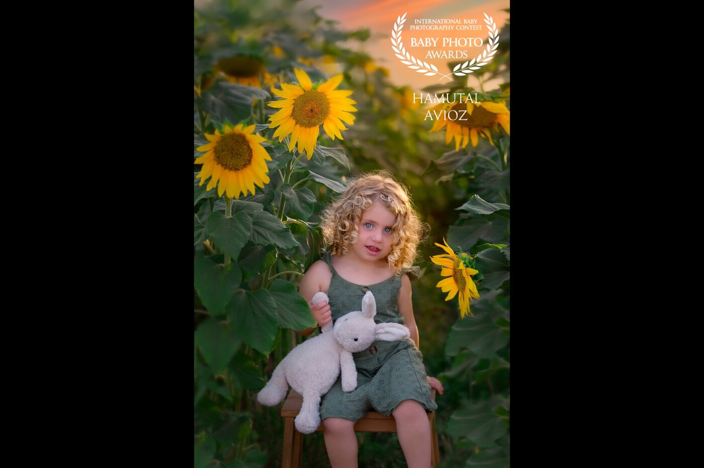 This photo of Yaara was taken in the sunflower field. It is my favorite flower. I just love the way the color of her clothe and hair blends in the field, and her magical eyes pop out. The magic hour light add the final touch.