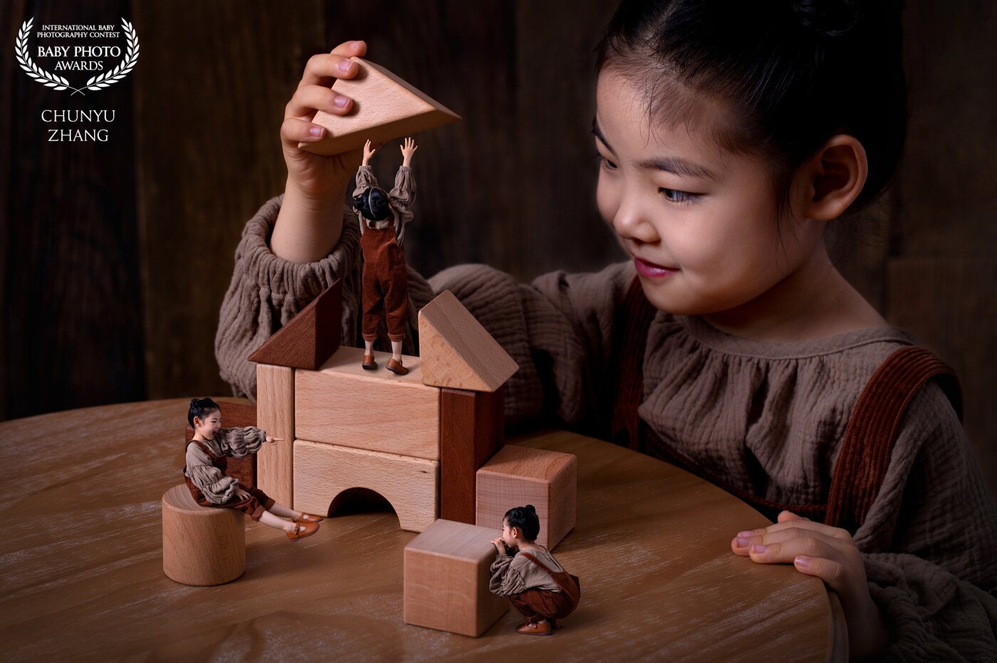 A beautiful girl is building blocks. Her dexterous hands are busy in "Building Block World".Look!  She is also the little one. One is playing peekaboo, the other is doing some some lifting work.