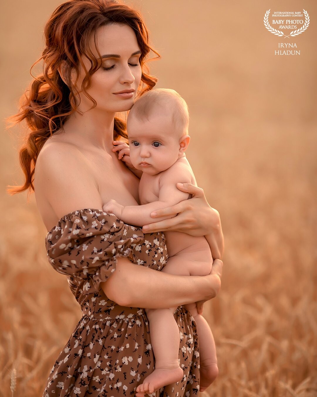 Sensual love story of a mother for her baby. Filmed in a wheat field in the rays of the setting sun. Mom hugs the baby and protects him from all the hardships of this world. With this photo I wanted to show all the power of mother's love.