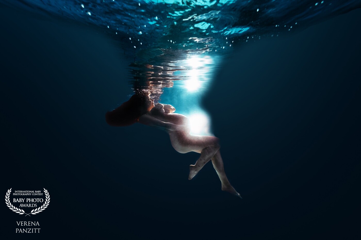 Underwater is such a unique way to photograph a woman. The weightlessness allows the woman to float and present her body in a elegant, graceful and uniquely way.  The pregnant woman floating in the water can also achieve the idea of the gracefulness and maternal image of her unborn baby that floats on her womb.