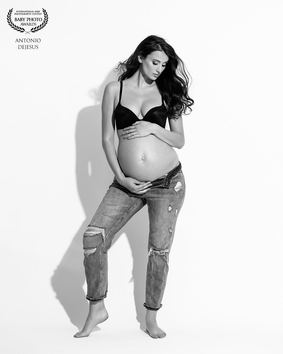 A mother expecting her second baby boy with an editorial high-key look! The black brazier and designer jeans is a great way to showcase the beauty can be casual.