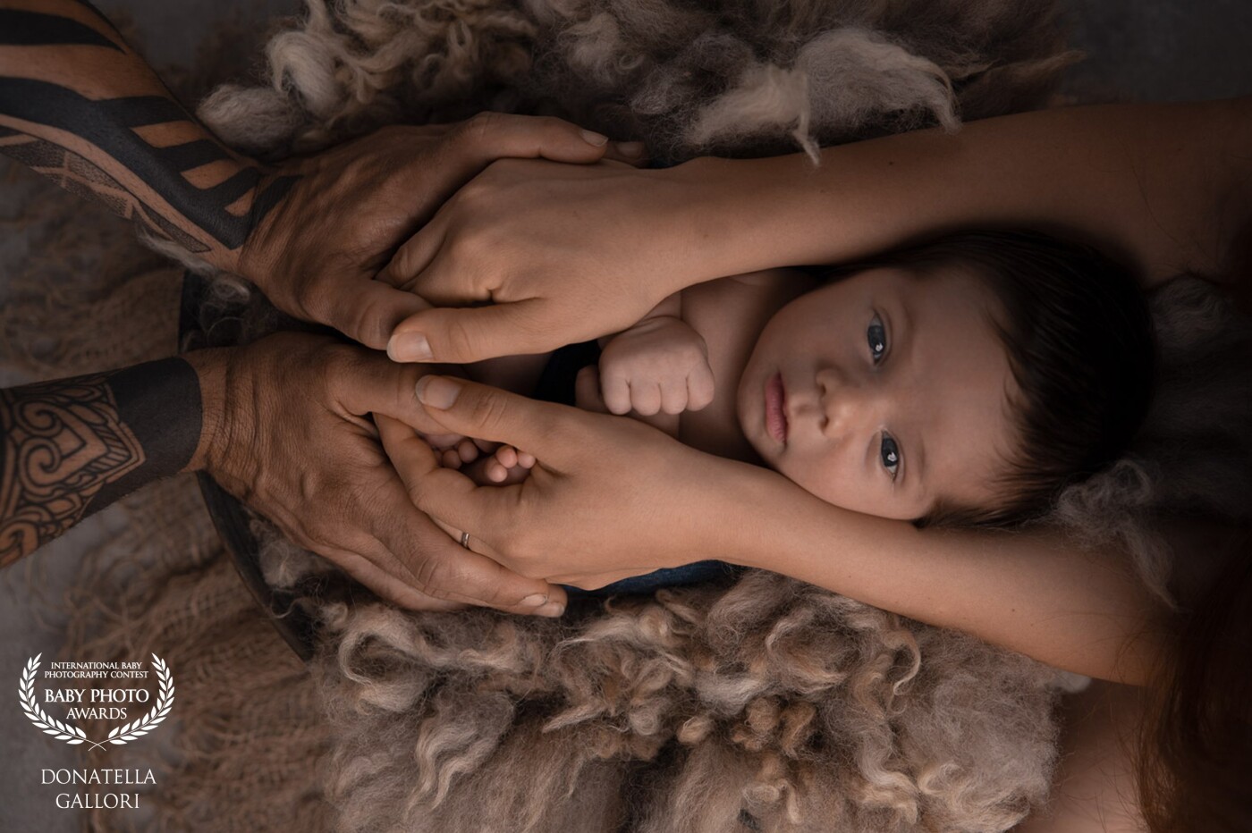 The safest place in the world<br />
<br />
The wonder of Tommaso's gaze, 14 days old, in the sure embrace of mom and dad. The details of the hands suggest the emotion and love of these two new parents in a tender and delicate way