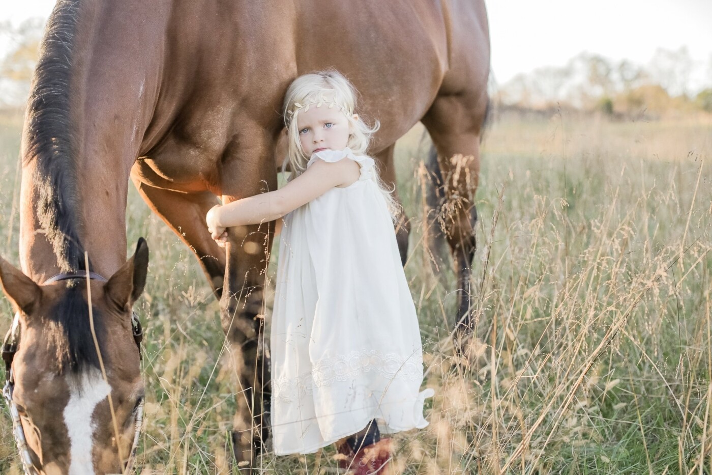 This is actually my daughter Sullivan Mae with my horse Dawn. I got Dawn when I was 12 and have had her for 19 years.  I showed her competitively through the American Quarter Horse Association until I retired her a few years ago.<br />
When Sullivan was born she was instantly attracted to animals, especially Dawn. Before she could speak she would say "neigh" and point to the door asking to go to the barn.<br />
As Dawn is getting older, I know our time with her is shorter than I would like to admit and my days of watching the love between my daughter and my horse will not be forever.<br />
My goal with this shoot was to document their relationship, their bond, the peace they have with each other and their comfort of just being next to each other. It's an image I will cherish forever.