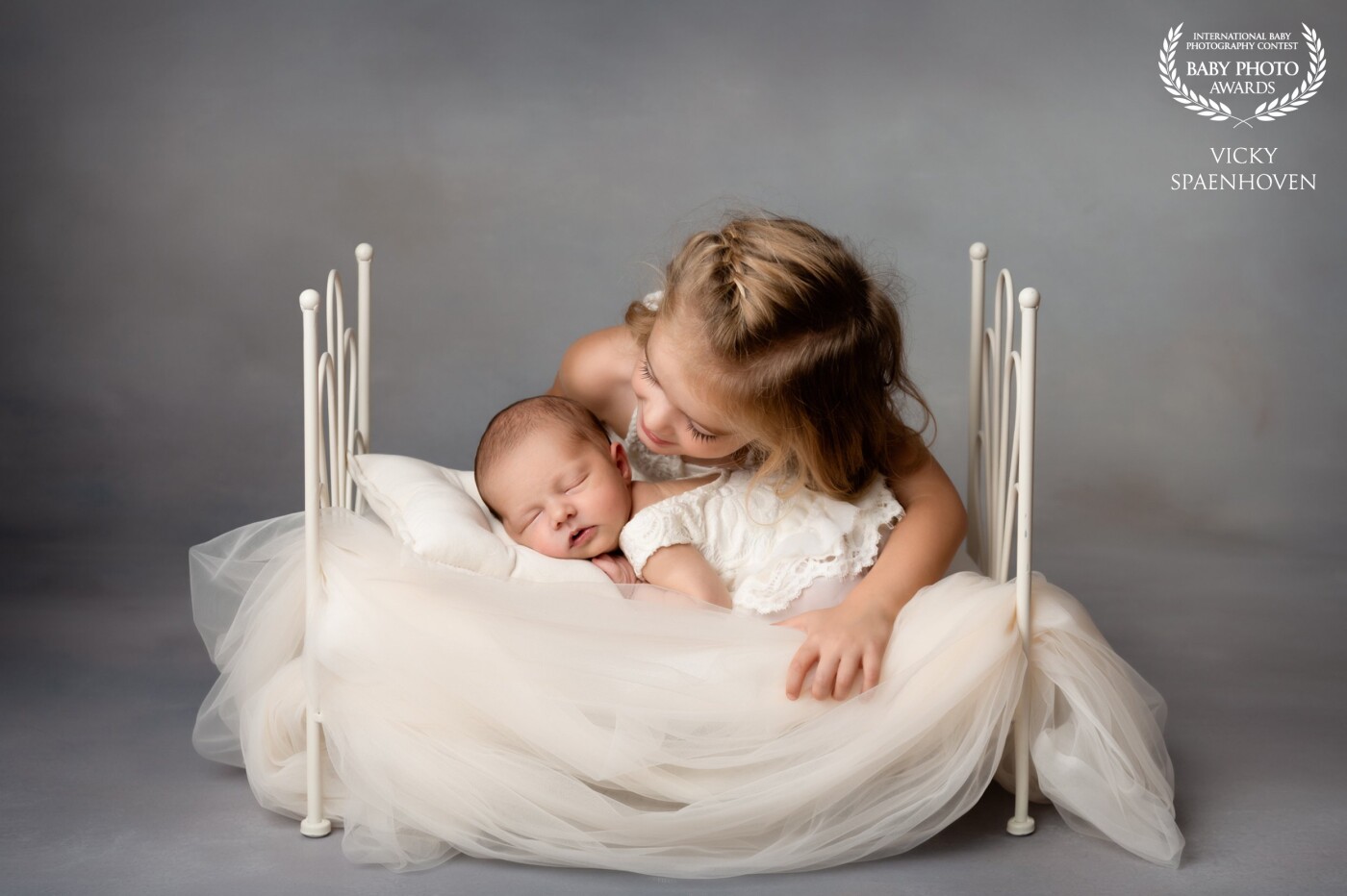 How beautiful are these two sisters? I love the connection between them and the use of soft light and soft color tones. It's not easy to photograph young children together, but if you have patience, you can create something very special.