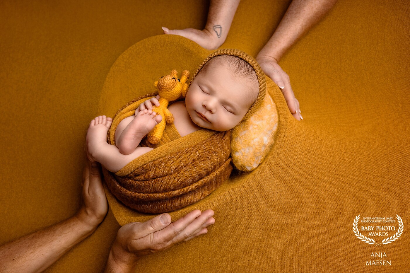 I loved to incorporate the parents' hands in this heart pose... This little man was just so sweet and the mustard colour pops out but keeps the attention on the baby...
