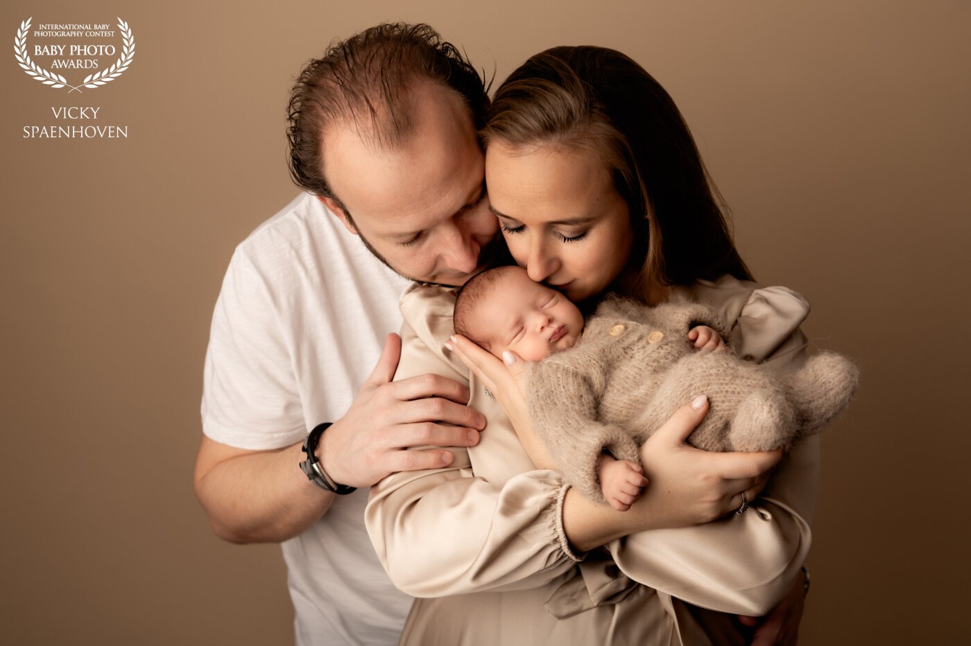 Beautiful mom and dad with their sweet girl Olivia. I love the warm and soft color tones in this picture. A tender moment that will last forever.